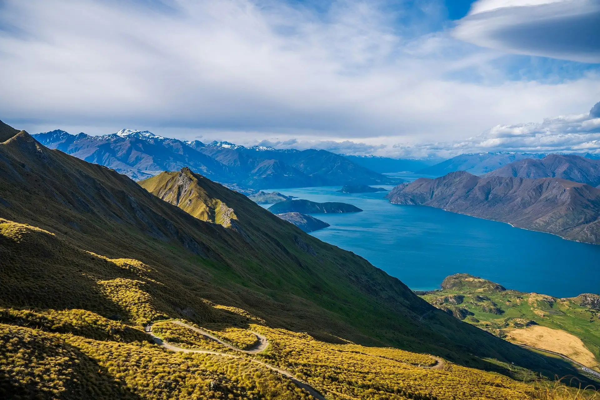 Lake Wanaka and the ranges seen from golden tussock hills