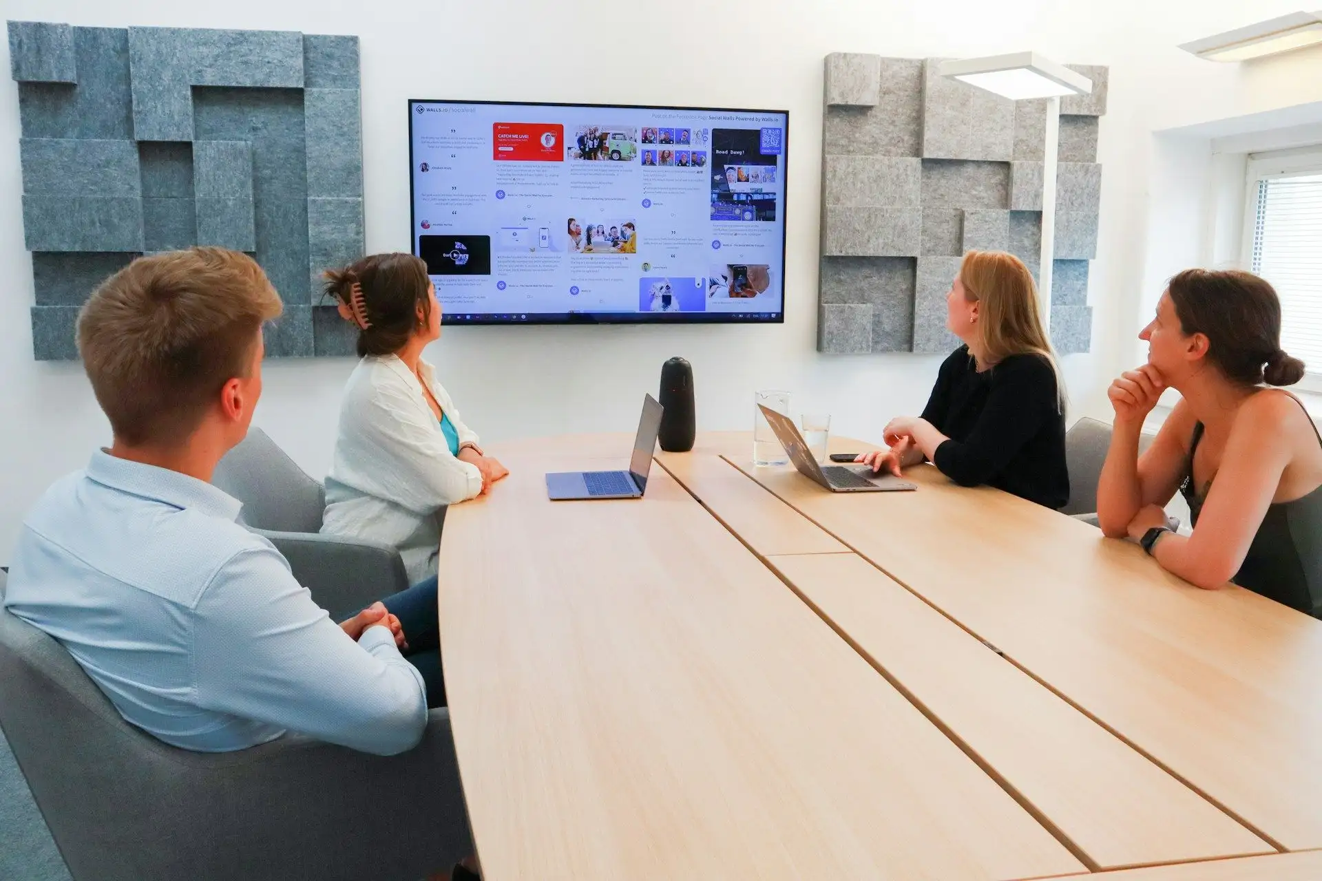 Colleagues reviewing a presentation on a wall screen