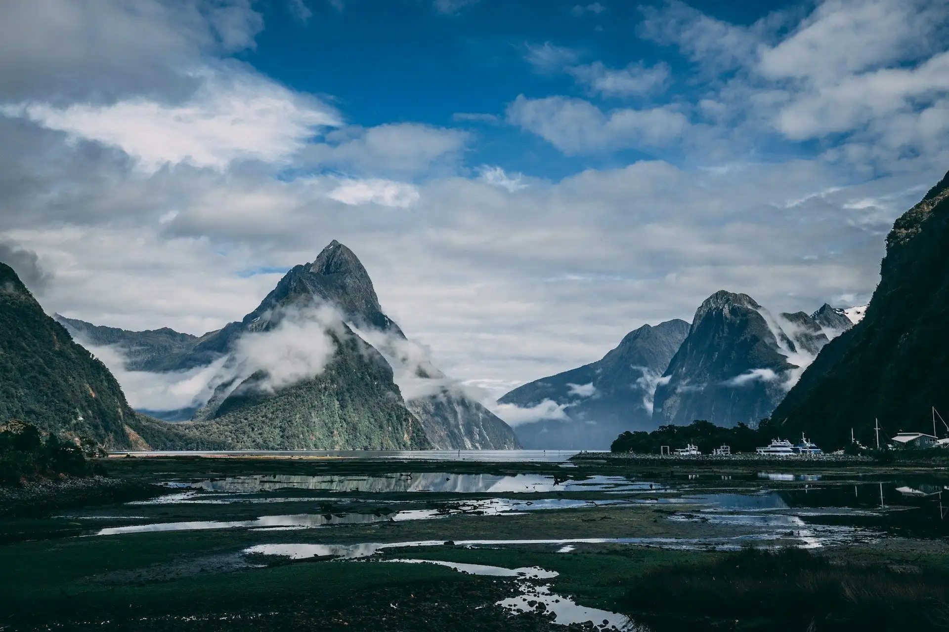 Mitre Peak rising through cloud above Milford Sound