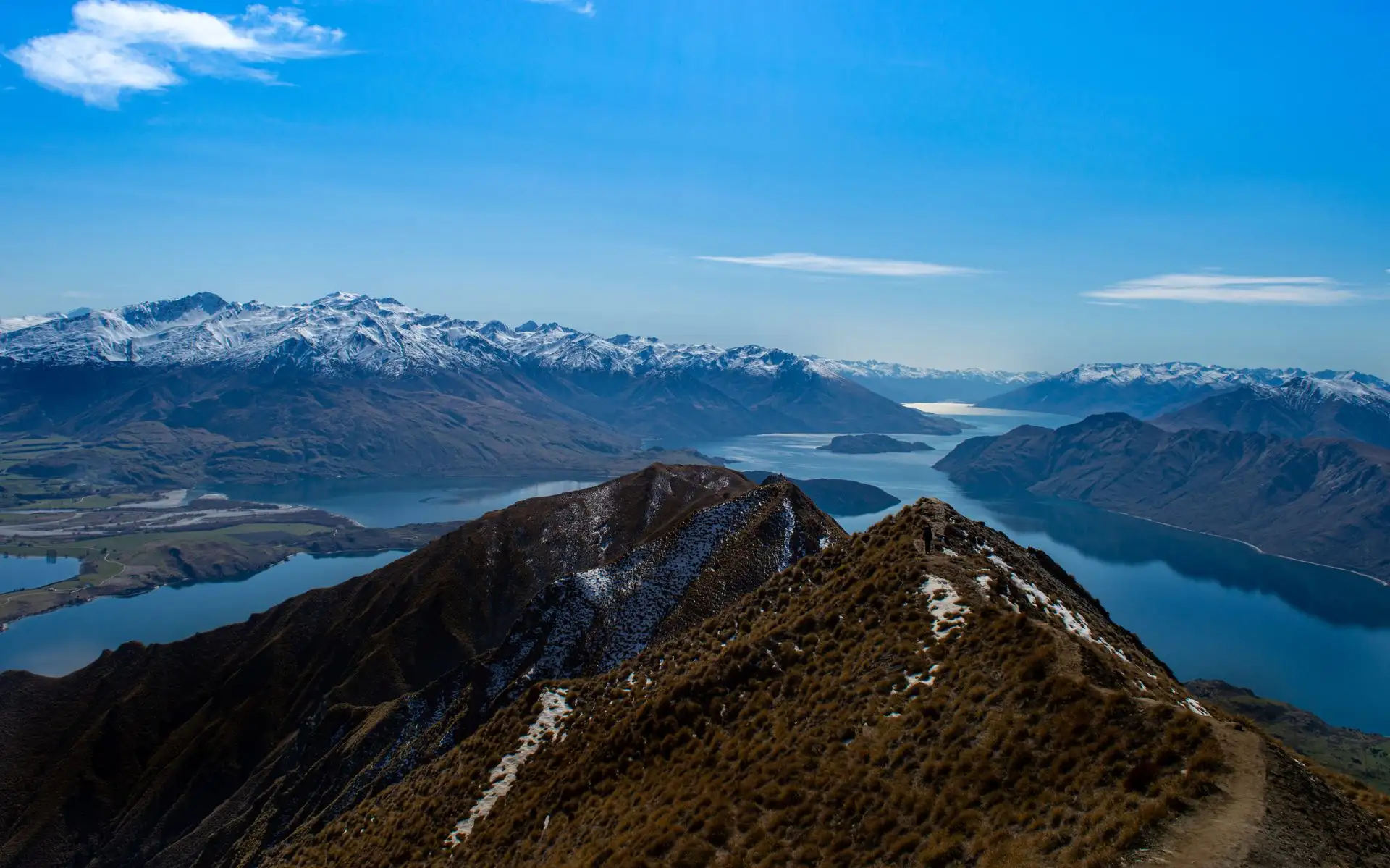 The Roys Peak ridge and blue Lake Wanaka under a blue sky